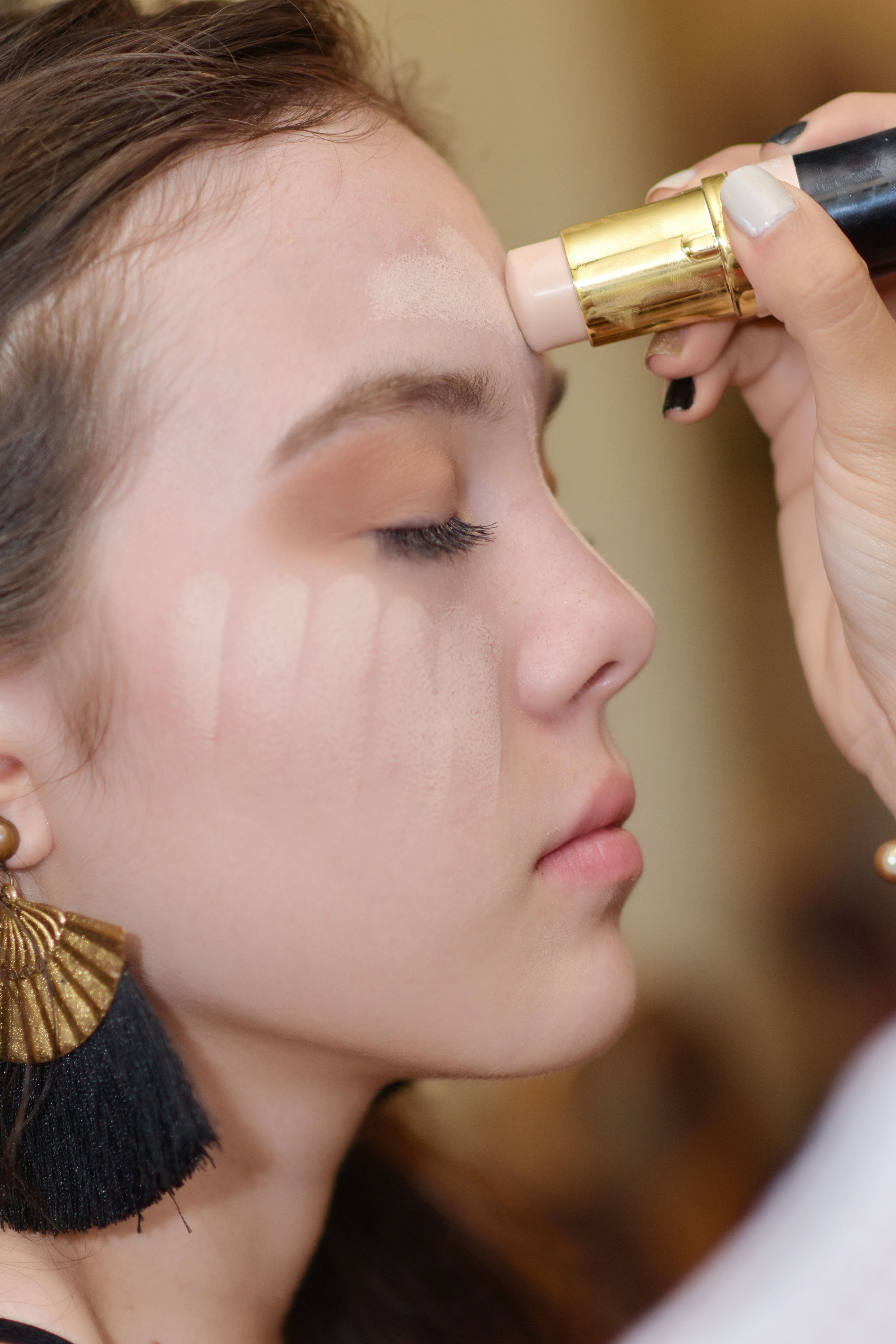 Applying tinted moisturizer with a foundation stick
